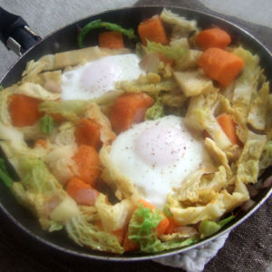 Sauteed sweet potatoes and cabbage with fried eggs